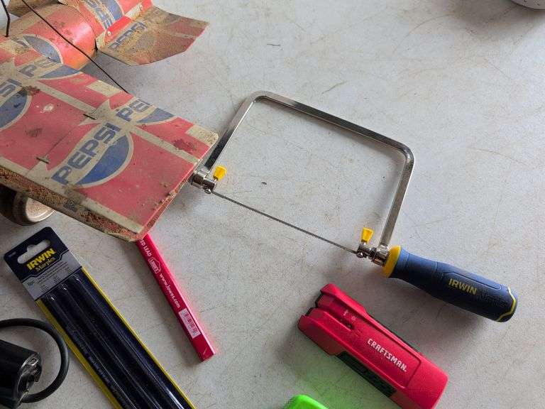 Black and Decker drill, Dremel and accessories, saw, staple gun, other tools, and model airplane