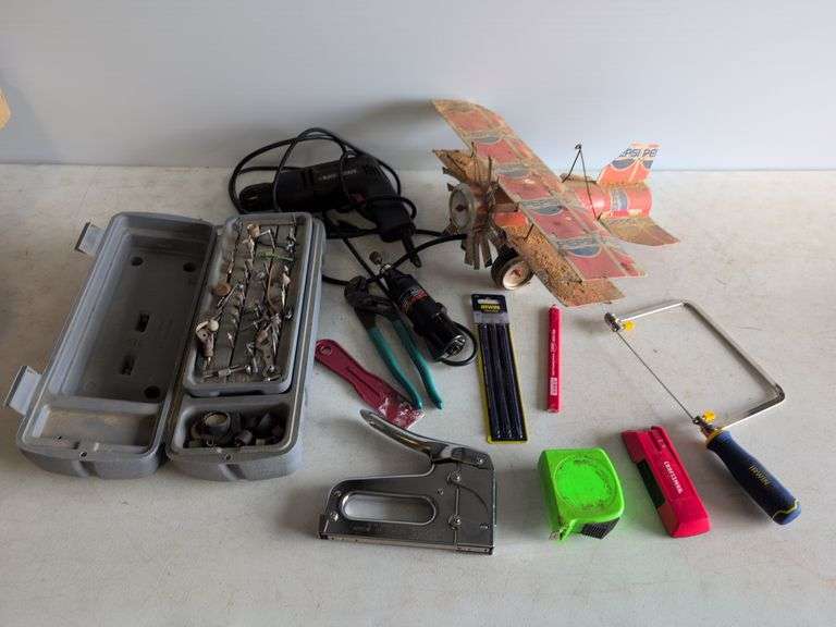 Black and Decker drill, Dremel and accessories, saw, staple gun, other tools, and model airplane