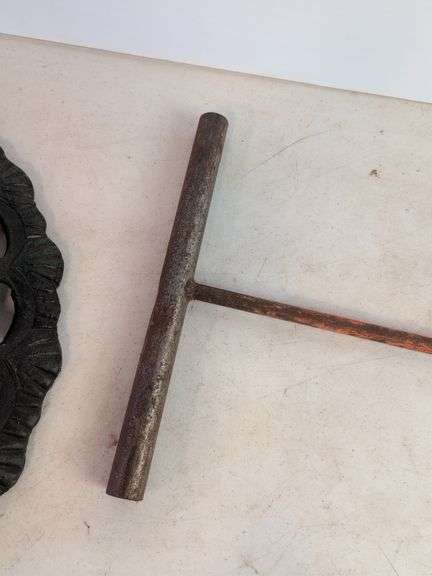 Large cast iron decorative piece and t-handled tool
