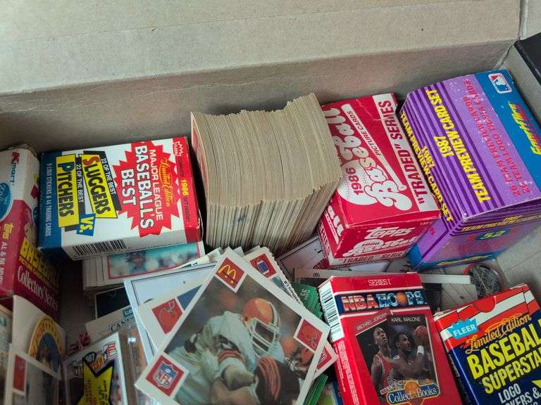 Football, baseball, and basketball trading cards with extra binder sleeves