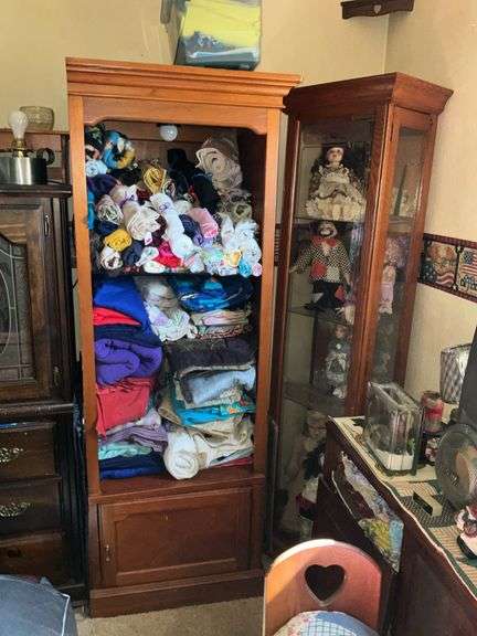 BOOKSHELF AND GLASS SHOWCASE W/ALL DOLLS. BLANKETS, AND FABRIC REMNANTS