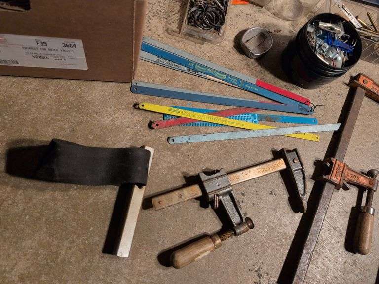 Miscellaneous tools and hardware - gas can, clamps, scythe, railroad nails, hacksaw blades, and more