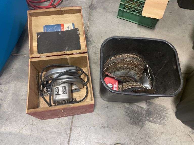Bingham 6.5" circular saw and bin of various saw blades
