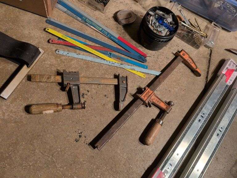 Miscellaneous tools and hardware - gas can, clamps, scythe, railroad nails, hacksaw blades, and more
