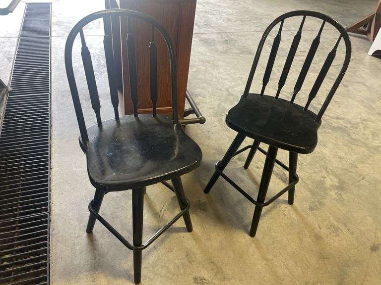 (2) matching black wooden swivel chairs