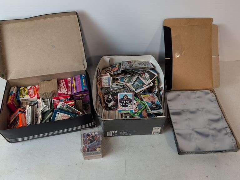 Football, baseball, and basketball trading cards with extra binder sleeves