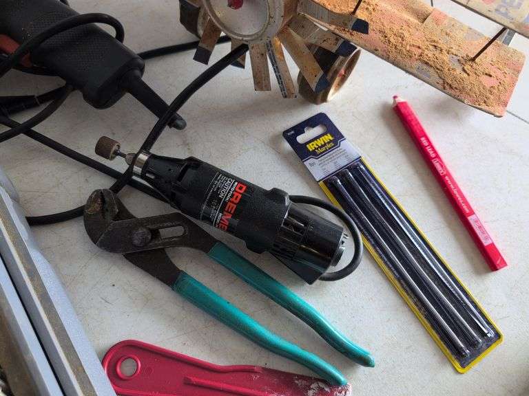 Black and Decker drill, Dremel and accessories, saw, staple gun, other tools, and model airplane