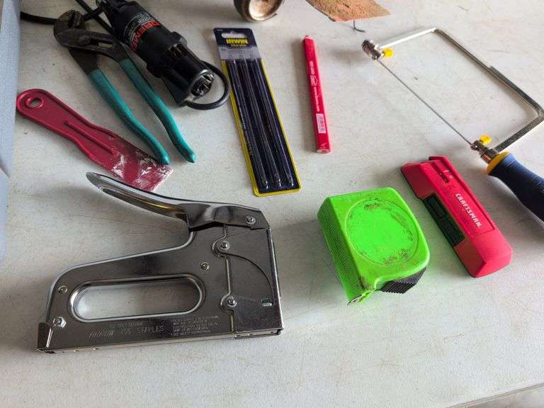 Black and Decker drill, Dremel and accessories, saw, staple gun, other tools, and model airplane
