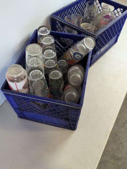 Bar glasses with sports logos in (2) milk crates