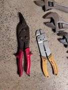 (5) adjustable wrenches, wire stripper, and metal snips