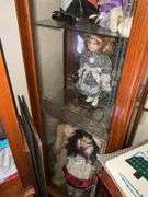 BOOKSHELF AND GLASS SHOWCASE W/ALL DOLLS. BLANKETS, AND FABRIC REMNANTS