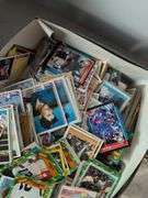 Football, baseball, and basketball trading cards with extra binder sleeves