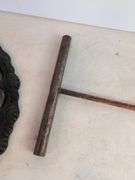 Large cast iron decorative piece and t-handled tool
