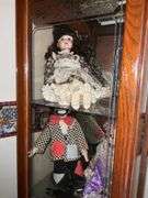 BOOKSHELF AND GLASS SHOWCASE W/ALL DOLLS. BLANKETS, AND FABRIC REMNANTS