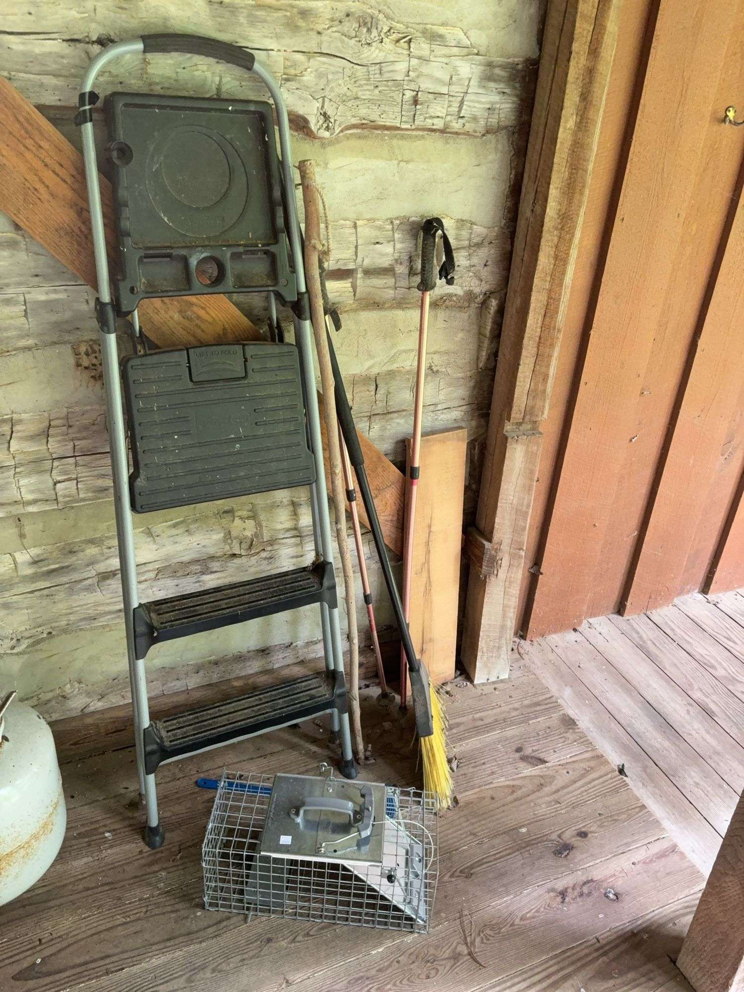 Step ladder, live animal trap, broom, and walking sticks