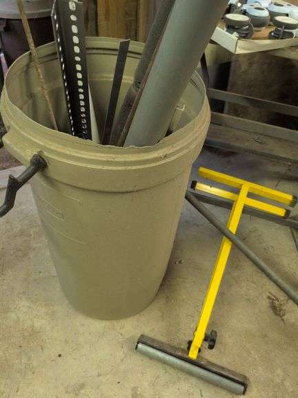 Trash barrel with piping, work stand, conduit bender, and roller