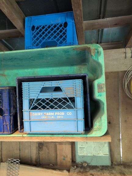 Contents of corner - live animal traps, milk crates, battery charger, and signs