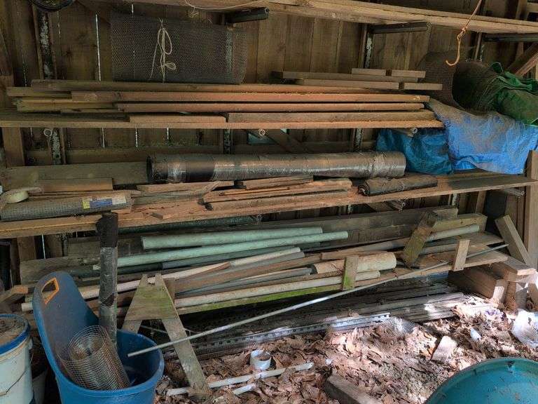Contents of shelves - lumber, PVC piping, metal piping, tarps, and more