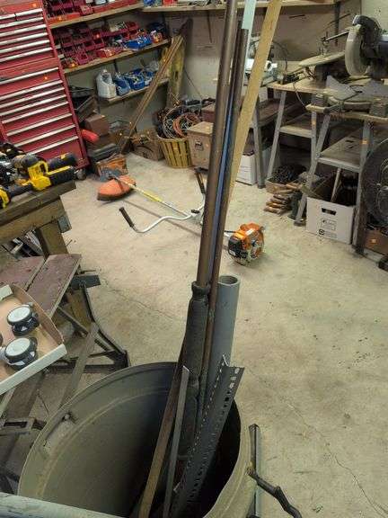 Trash barrel with piping, work stand, conduit bender, and roller