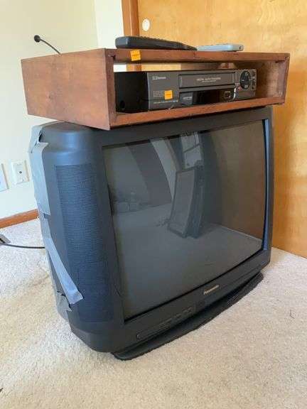 Panasonic 27” Colored Television, Emerson Video Cassette Player, Mounting Box