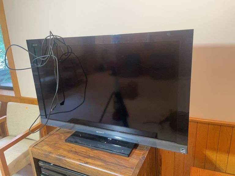 Wooden rolling stand with 40" Sony TV and DVD player and recorder