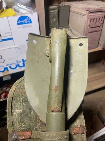 Assortment of ammo boxes and military shovels
