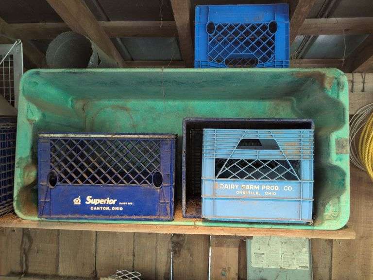 Contents of corner - live animal traps, milk crates, battery charger, and signs