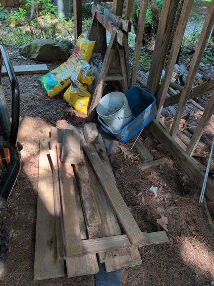 (2) saw horses, pile of wood, bucket, and potting mix