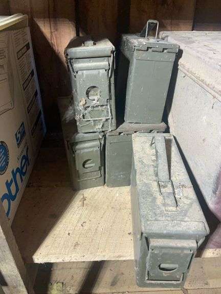 Assortment of ammo boxes and military shovels
