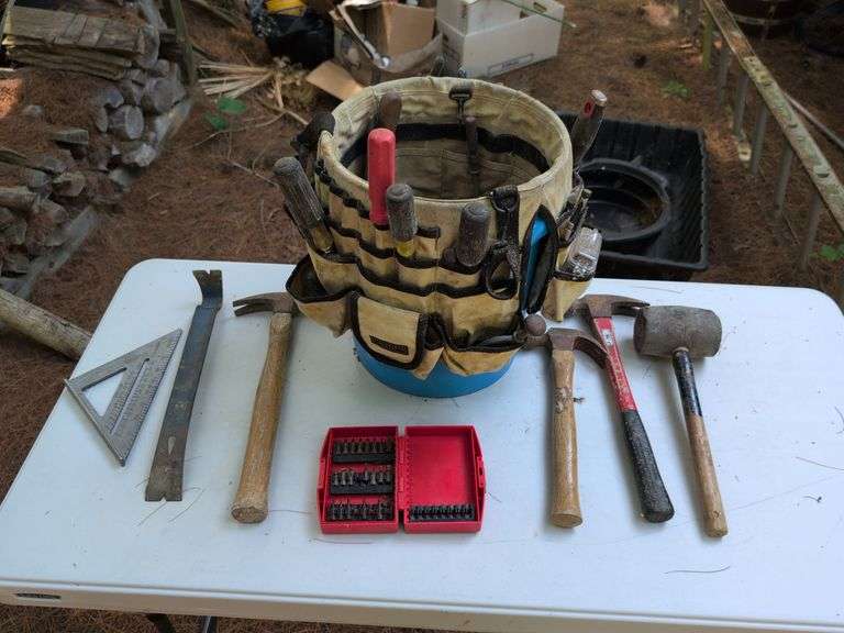 Bucket of tools - hammers, mallet, pry bar, square, screwdrivers, and more