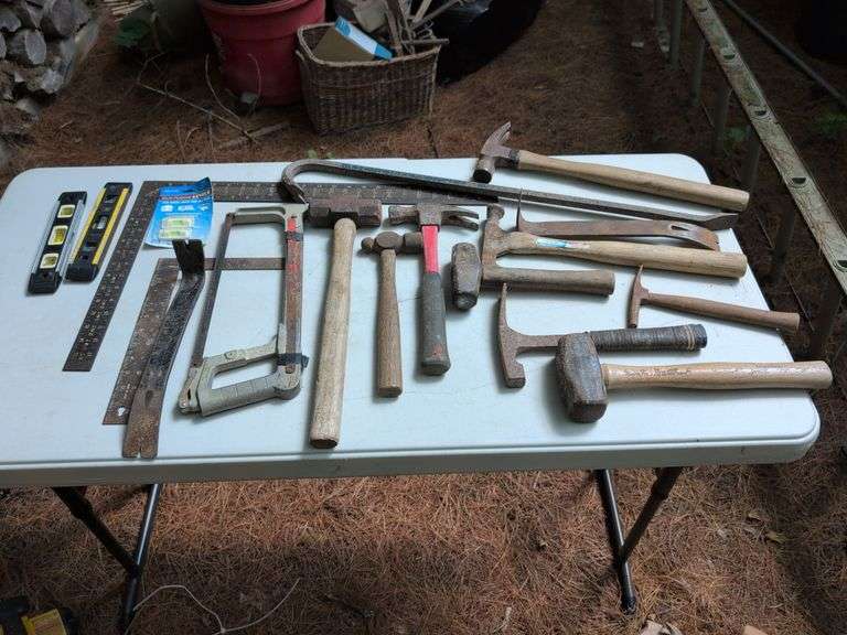 Hammers, pry bars, sledge, saw, and levels