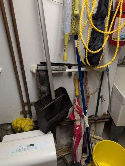 Contents of corner - dehumidifier, hard hat, cleaning items, and more