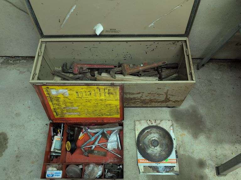 Metal cabinet of pipe wrenches, saw blades, and more