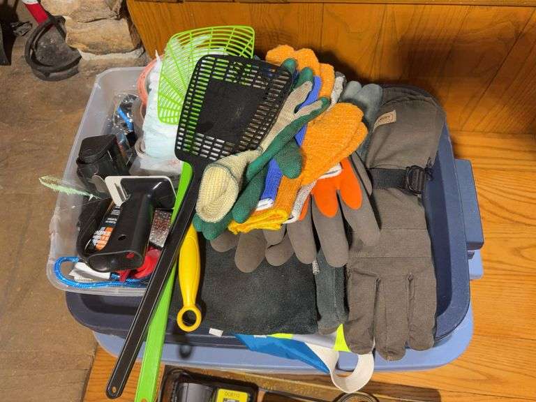 Totes with DeWalt walkie talkies, battery chargers, gloves, tape gun, and other items