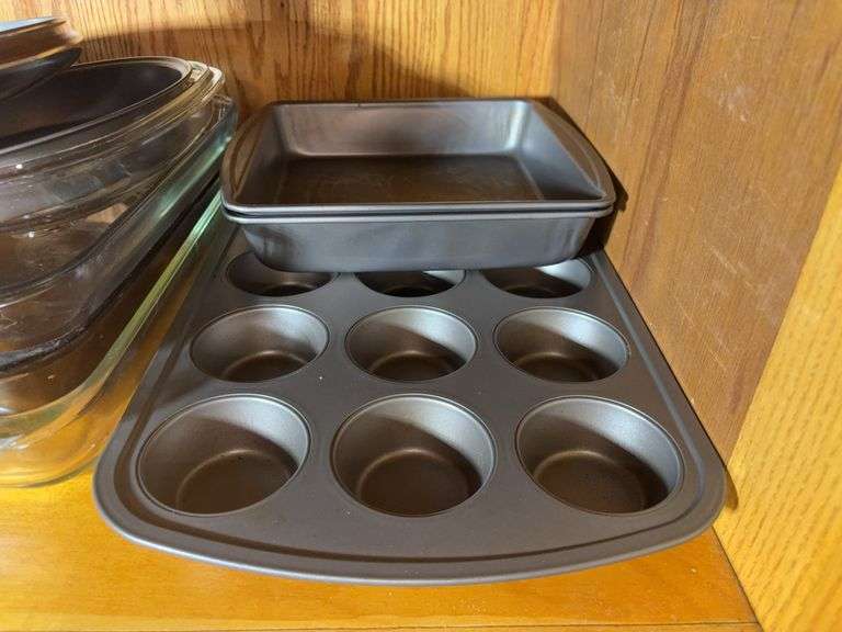 (2) shelves of stainless steel mixing bowls, cake pans, cupcake pan, loaf pans, and more