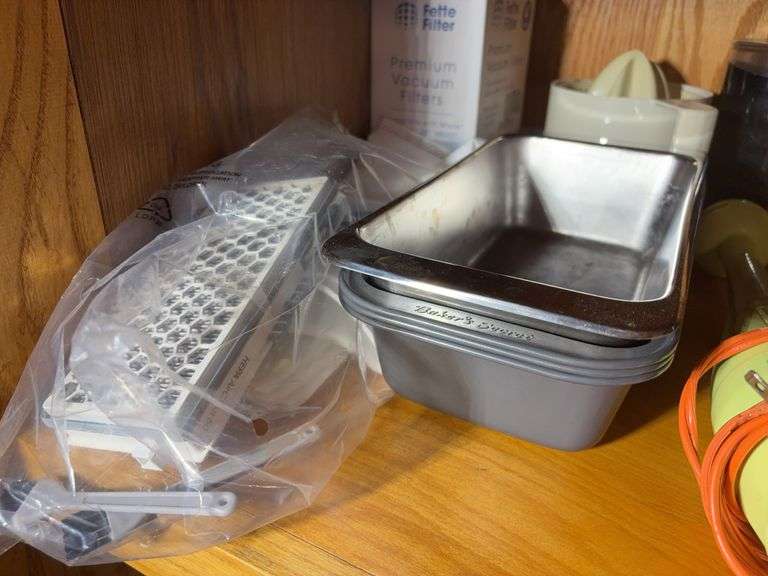 (2) shelves of stainless steel mixing bowls, cake pans, cupcake pan, loaf pans, and more
