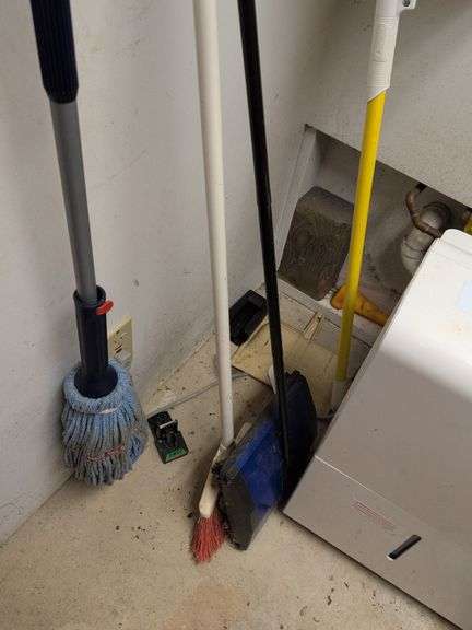 Contents of corner - dehumidifier, hard hat, cleaning items, and more