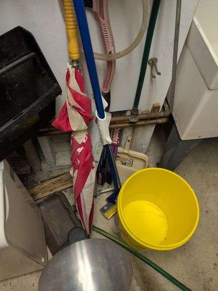 Contents of corner - dehumidifier, hard hat, cleaning items, and more