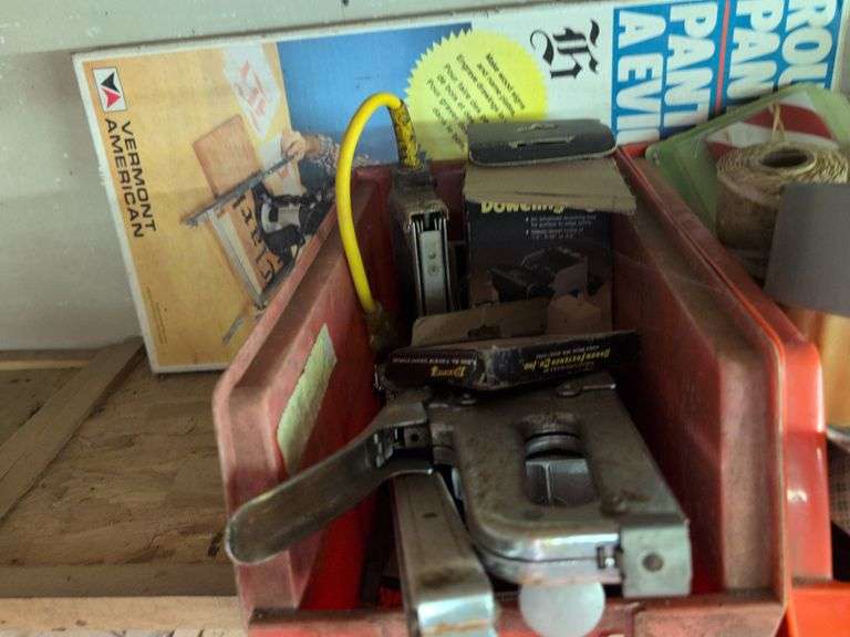 Contents of shelf - staple guns, tape, paint brushes, and more