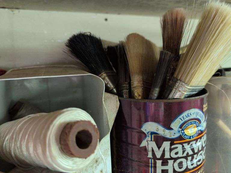 Contents of shelf - staple guns, tape, paint brushes, and more