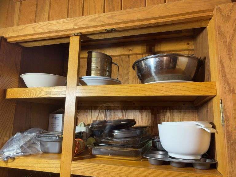 (2) shelves of stainless steel mixing bowls, cake pans, cupcake pan, loaf pans, and more