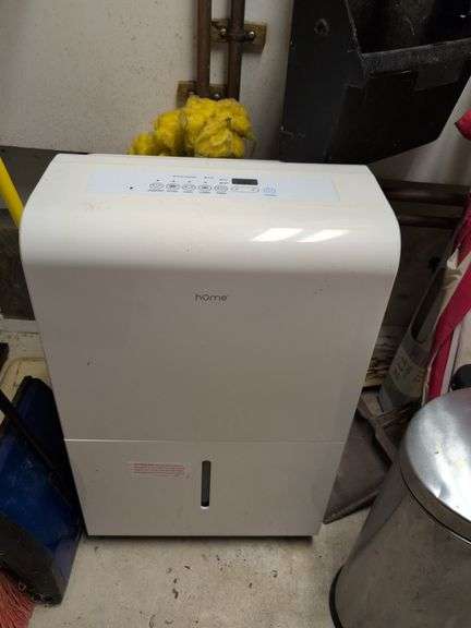 Contents of corner - dehumidifier, hard hat, cleaning items, and more