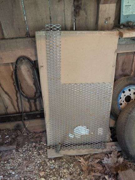 Contents of corner - live animal traps, milk crates, battery charger, and signs