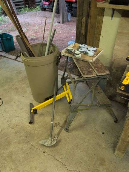 Trash barrel with piping, work stand, conduit bender, and roller