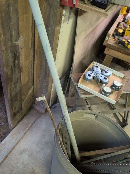 Trash barrel with piping, work stand, conduit bender, and roller
