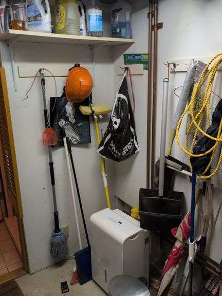 Contents of corner - dehumidifier, hard hat, cleaning items, and more