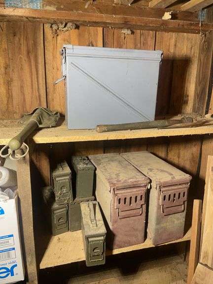 Assortment of ammo boxes and military shovels