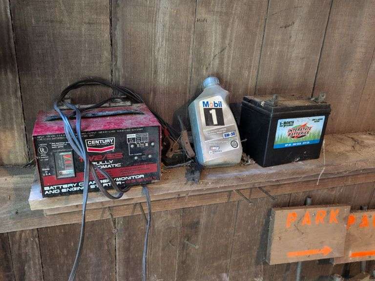 Contents of corner - live animal traps, milk crates, battery charger, and signs