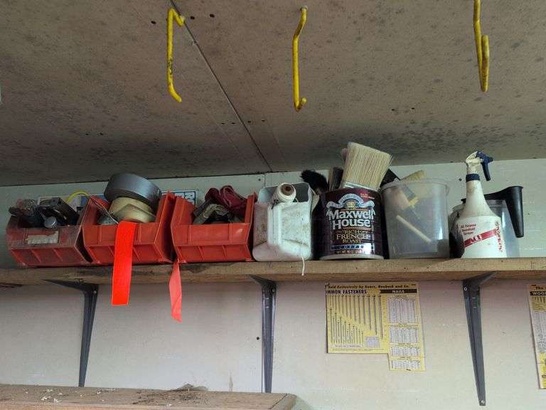 Contents of shelf - staple guns, tape, paint brushes, and more