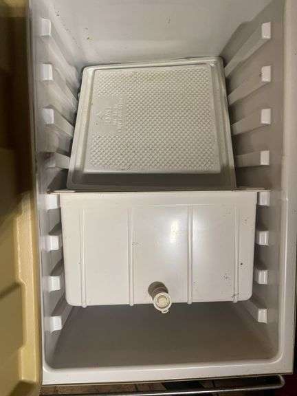 Small step ladder, mop bucket, and Coleman 3-way cooler